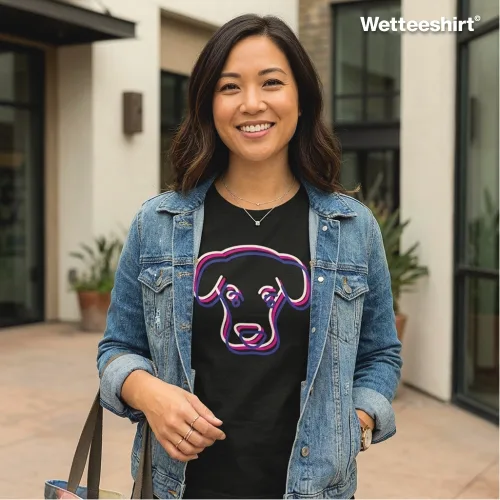 Person in denim jacket wearing black neon dog graphic T-shirt with purple and pink design, casual unisex streetwear by Wetteeshirt®, premium cotton tee, trendy urban fashion outfit for men and women, stylish pet‑inspired apparel in Singapore.