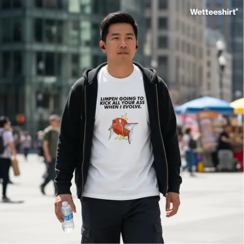 Unisex white short sleeve T-shirt with cartoon fish graphic and bold slogan “I’M GONNA KICK IN YOUR ASS WHEN I EVOLVE,” playful Singapore streetwear by Wet Tee Shirt®