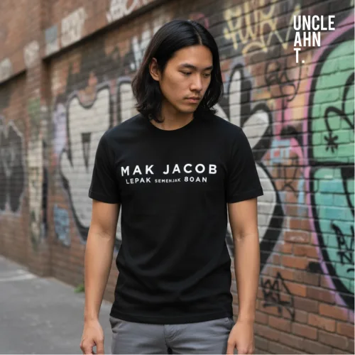 Singapore streetwear MAK JACOB LEPAK KENCANG ROAN black short sleeve T-shirt, bold white text design, casual unisex tee by Uncle Ahn T, premium cotton playful design photographed in urban graffiti alley