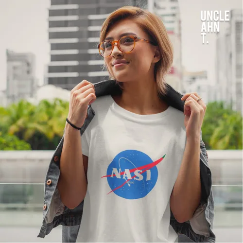 Singapore streetwear NASI white short sleeve T-shirt, parody of NASA logo with bold colorful design, casual unisex tee by Uncle Ahn T, premium cotton humorous design photographed outdoors in urban setting