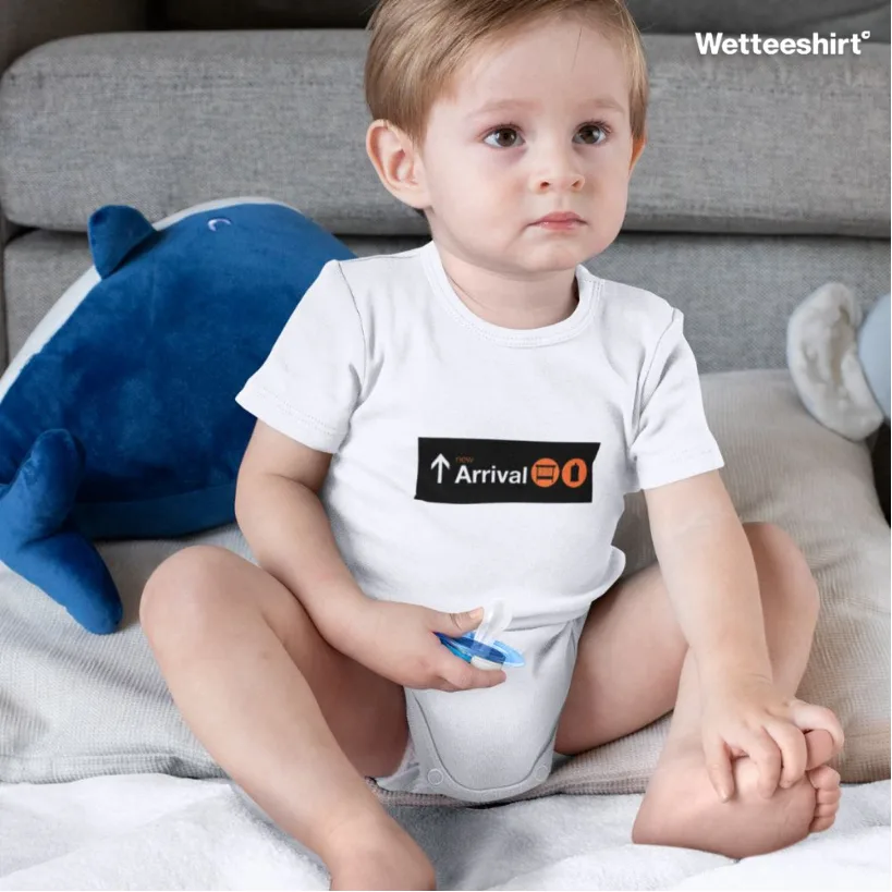 White baby onesie with Arrival arrow and orange reset icon, playful newborn design by Wet Tee Shirt®
