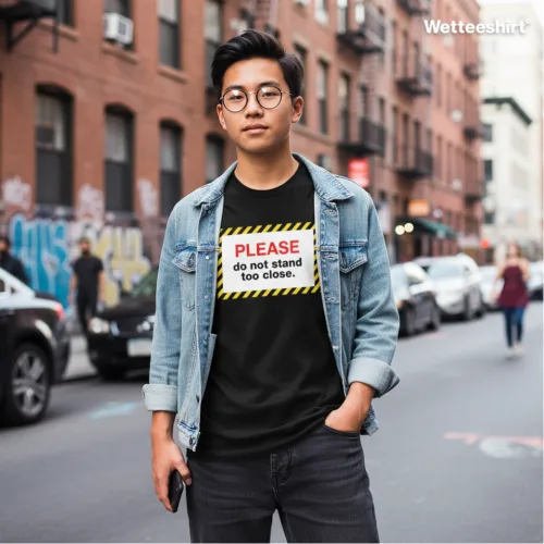 Unisex black short sleeve T-shirt with bold white “PLEASE do not stand too close” slogan, witty Singapore streetwear by Wet Tee Shirt®