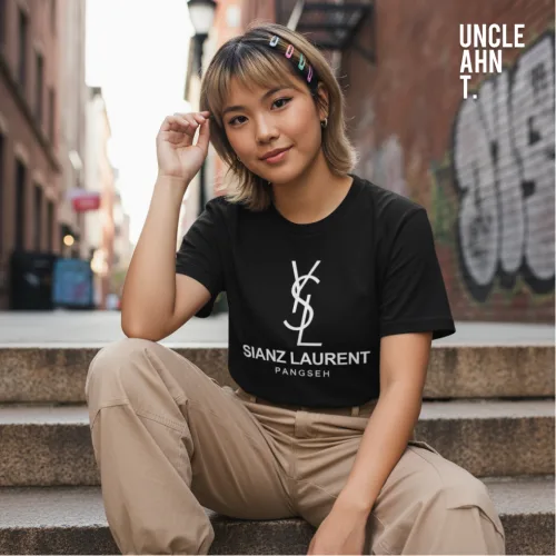 Singapore streetwear SIANZ LAURENT PANGSEH black short sleeve T-shirt, bold white parody text with logo, casual unisex tee by Uncle Ahn T, premium cotton playful design photographed outdoors in urban graffiti street setting