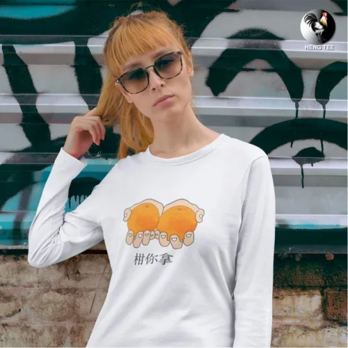 Unisex white long sleeve T-shirt with playful illustration of two hands holding oranges and bold Chinese text “桔你拿,” witty Singapore streetwear by Wet Tee Shirt®