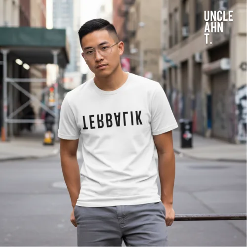 Singapore streetwear LEBBATIK white short sleeve T-shirt, bold black text design, casual unisex tee by Uncle Ahn T, premium cotton playful design photographed outdoors in urban street setting