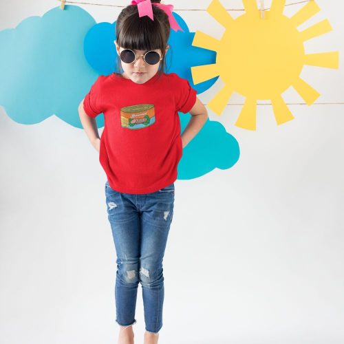 little-girl-wearing-a-tshirt-mockup-making-faces-against-cardboard-clouds-and-sun-.jpg