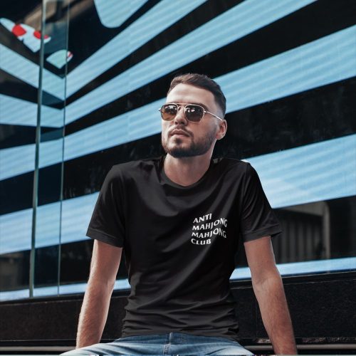 mockup-front-view-of-a-man-wearing-black-tee-sitting-on-a-flight-of-stairs.jpg