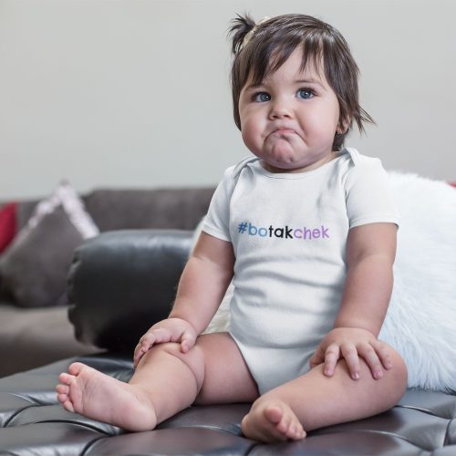 mockup-of-a-sad-baby-girl-wearing-a-onesie-sitting-on-a-leather-couch.jpg